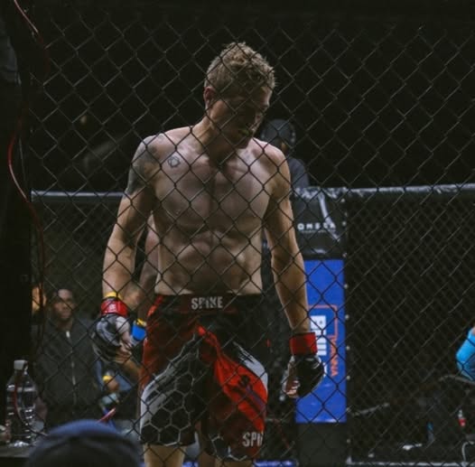 martial arts coach in a mma cage