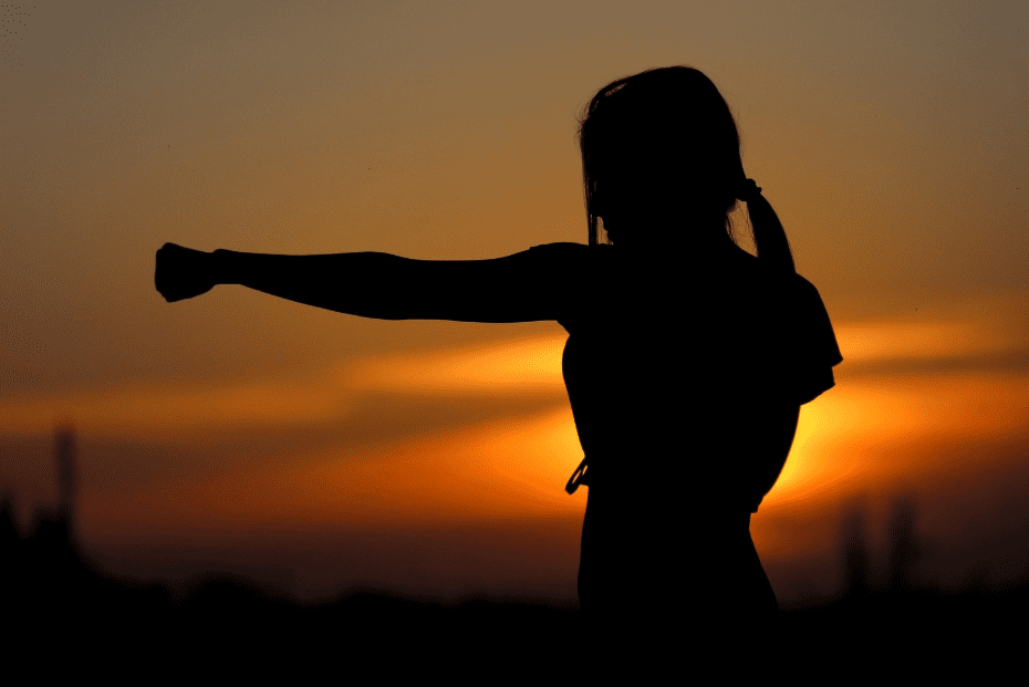 women throwing a punch outdoors on a hiking trail