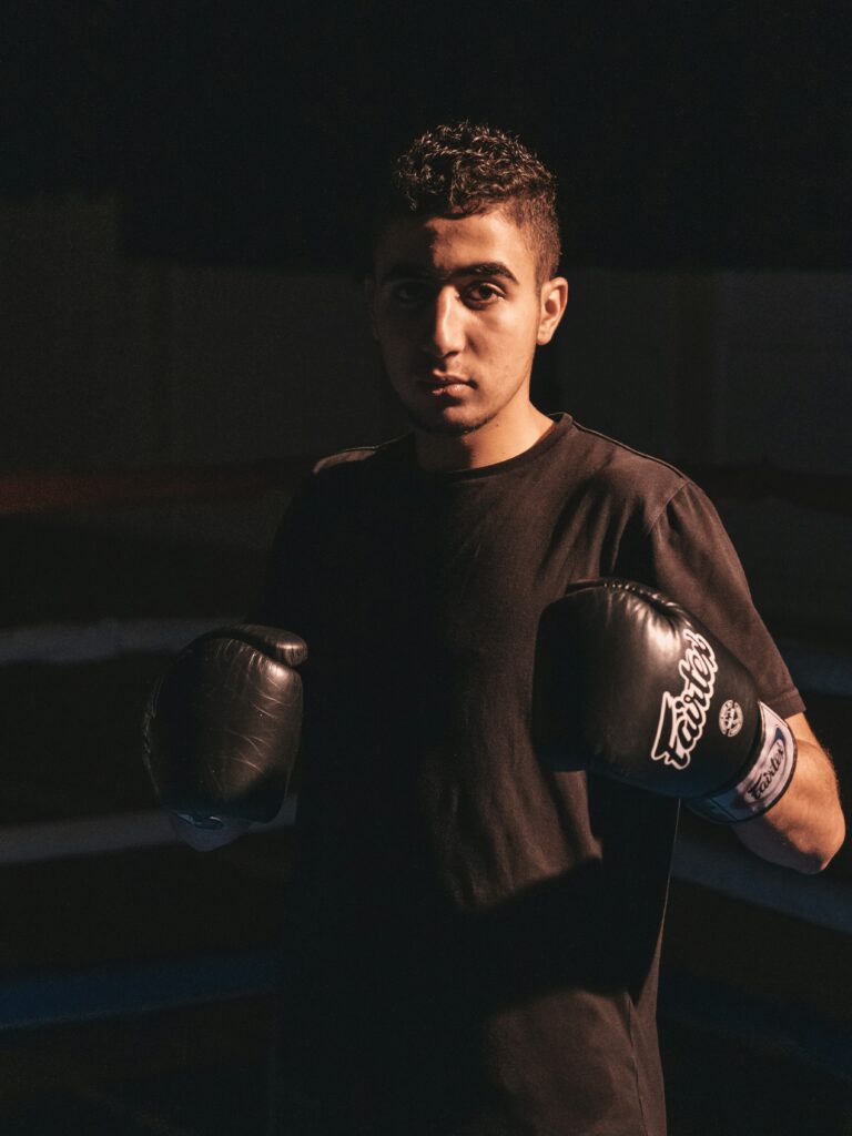 man posing with boxing gloves