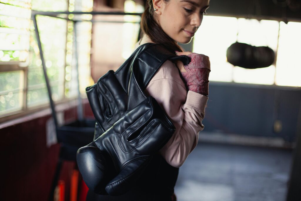 women with gloves over her shoulder self defense classes